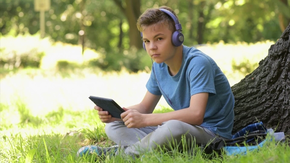 Boy With Tablet At Park