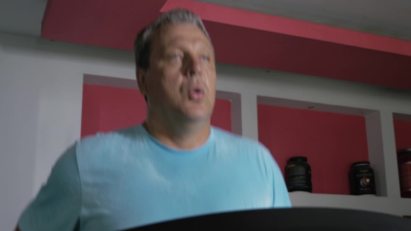Full Adult Male Runs On a Treadmill alt
