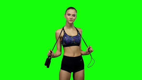 Woman Holding Jump Rope On Her Shoulders. Green Screen alt