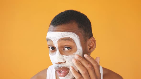 Portrait AfricanAmerican Man Cosmetic White Mask His Face Isolated Background He Likes To Take Care alt