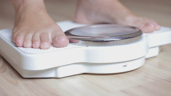The Girl Checks for the Weight on the Scales  alt