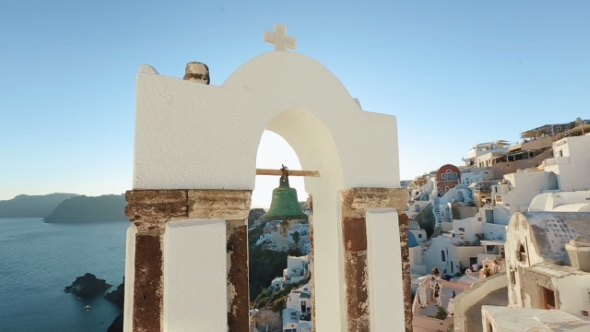 Calm Sea, White Church Arch, Cross, Bells On The Santorini Island, Greece.