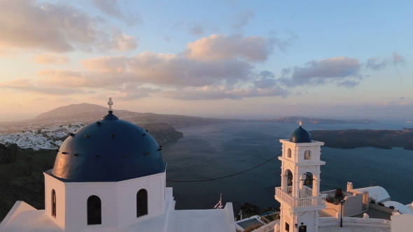 Santorini Church With Blue Dome By Aegean Sea. Church Bells On Santorini Island Which Is One Of The