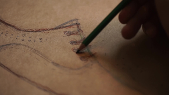  Of Designer Hand Drawing a Fashion Sketch In Details
