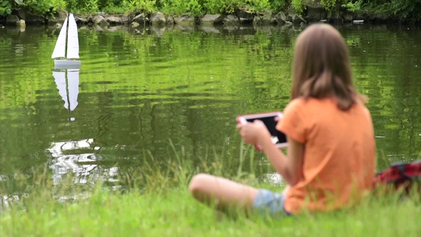 Girl With Remote Controlled Boat