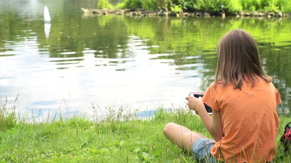 Girl With Remote Controlled Boat