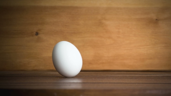 An Egg Is Rolling Across The Table. .