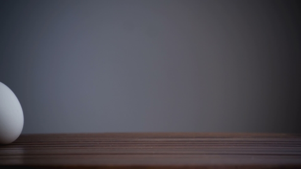 An Egg Is Rolling Across The Table. .
