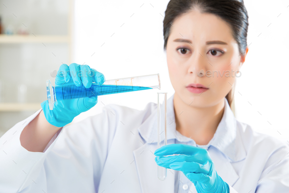 Asian female scientist Researcher observing indicator color shif