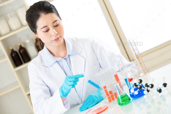 female scientist researcher observing indicator color shift