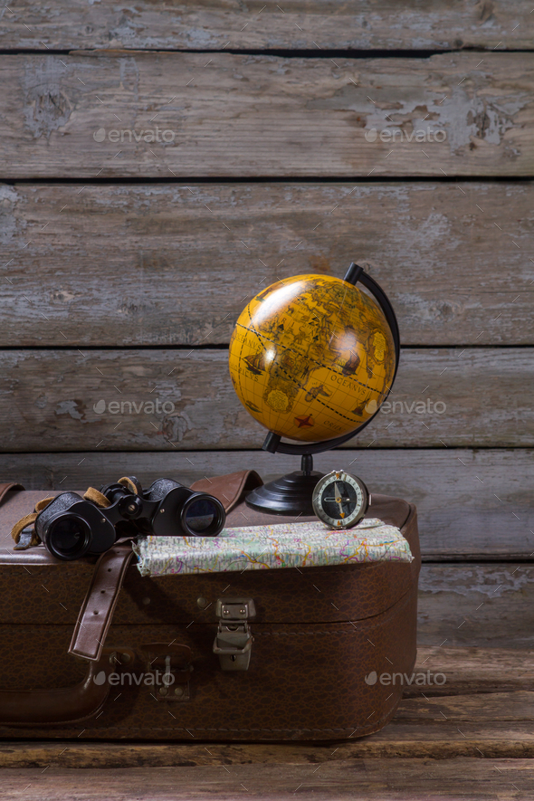 Globe and compass on suitcase
