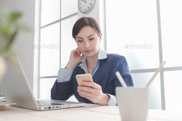 Businesswoman using mobile apps - Stock Photo - Images