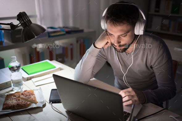 Handsome man connecting late at night - Stock Photo - Images