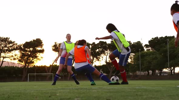 Female soccer player tackling down another player on soccer field. 4k alt