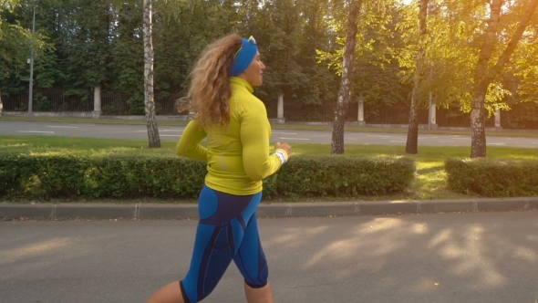 Woman Running In City Park To Lose Weight