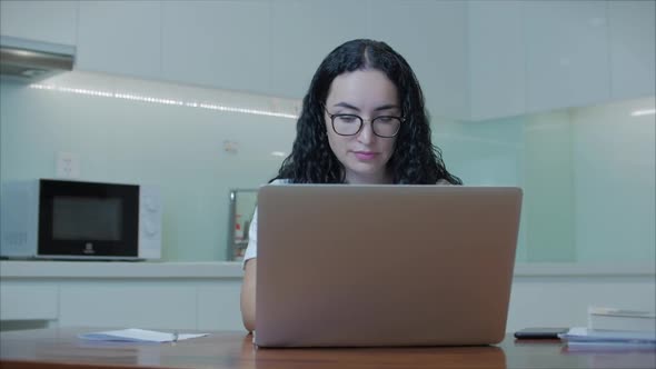 Woman Typing on Laptop Sitting on Sofa at Home, Businesswoman Sits at Home Types on Smartphone alt