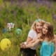 Two Young Pretty Girls Make Selfie. Students Are Sitting On The Lawn In The Park. Self-portrait - VideoHive Item for Sale