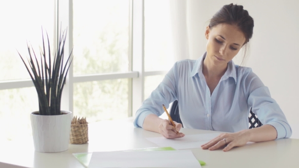 Young Beautiful Woman Draws A Sketch Of The Window In Office
