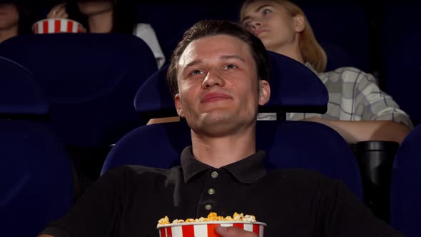 Happy Attractive Man Smiling To the Camera at the Cinema alt