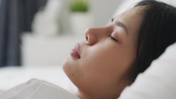 Face of Asian woman in bed have a good night sleep. alt