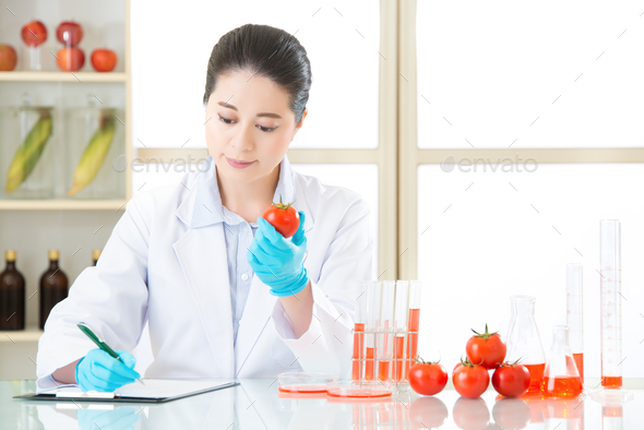 scientist Recording genetic modification data from examining