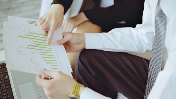Hands With Financial Charts At Business Meeting In The Office