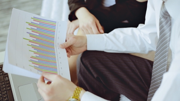 Two Businessmen Looking At Report And Having a Discussion In Office. 