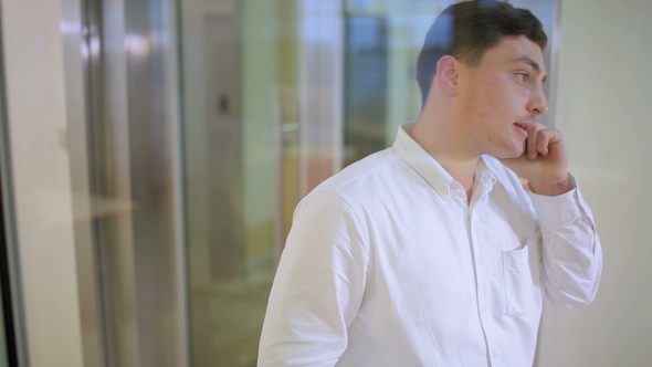 The Young Men Talking On The Phone In The Office alt