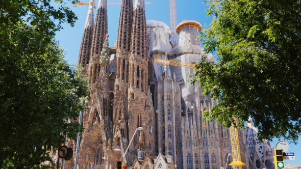 Sagrada Familia, Barcelona, Spain. Summer, On The Background Of Blue Sky alt