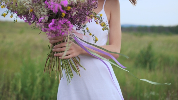 Beautiful Inspired Woman Holds a Bouquet Of Wildflowers. alt