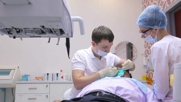 Dentist Is Healing The Teeth Of Male Patient With Dental Scaler And Mirror In Process Of Changing alt