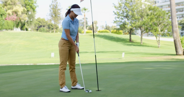 Woman Golfer About To Sink Her Putt, Stock Footage | VideoHive