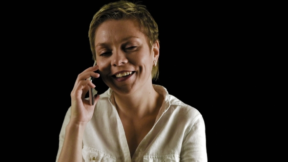 Short Hair Blond Woman Talks By Phone In Dark