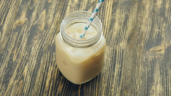 Glass Of Iced Coffee On Wooden Table alt