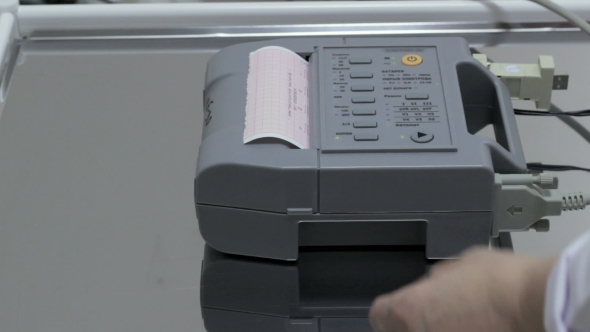 Cardiologist Doctor Presses Button Play On The ECG Device Cardiogram alt