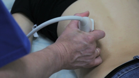 Doctor Removes a Sensor For Ultrasound Exploration Of The Human Body alt