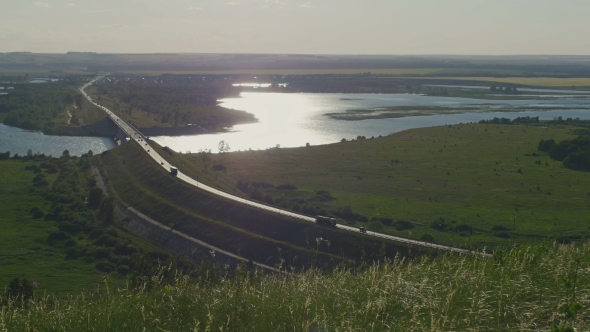 Rural Landscape. Green Meadow Against The River And Highway alt
