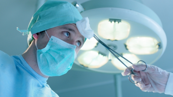 Wiping Sweat From Surgeon's Forehead alt