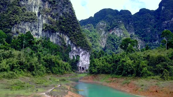 Cinematic Aerial Shot Flying Through Cheow Lan Lake Khao Sok Thailand alt