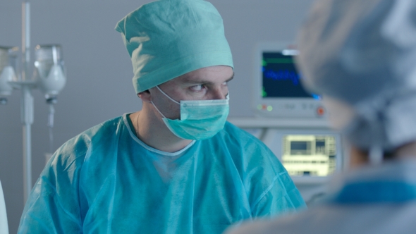 Two Surgeons Opetaring a Patient alt