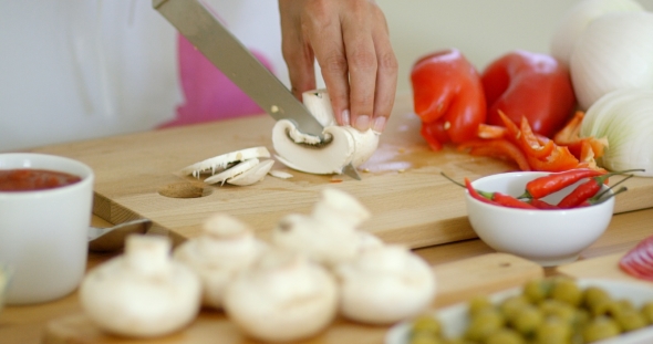 Housewife Preparing Dinner Slicing Fresh Mushrooms alt