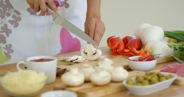 Housewife Preparing Dinner Slicing Fresh Mushrooms alt