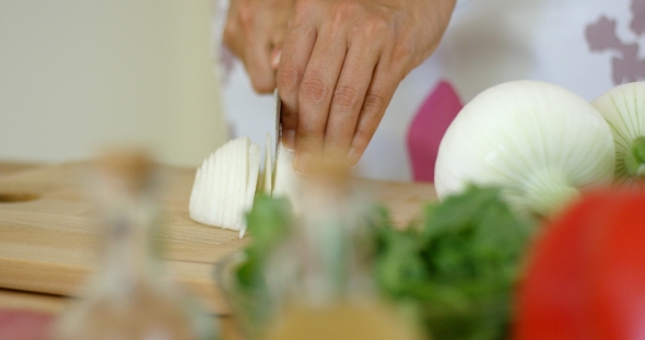  On Hands Cutting Fresh Onion alt