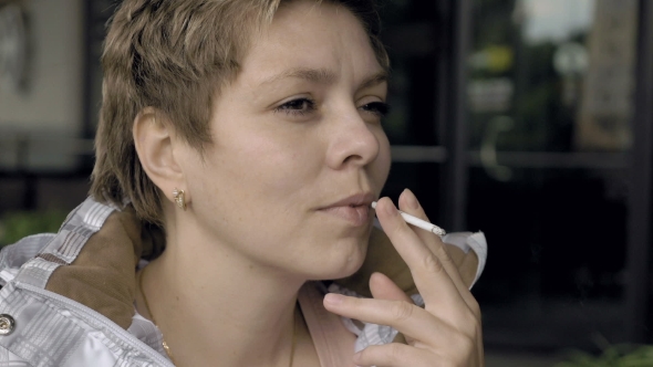 Smoking Female With a Cigarette In Her Hand