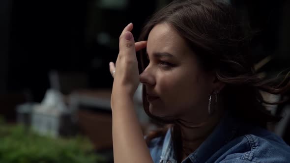 Portrait of a Young Woman with a Ring Earrings in Profile. the Camera Is Moving alt