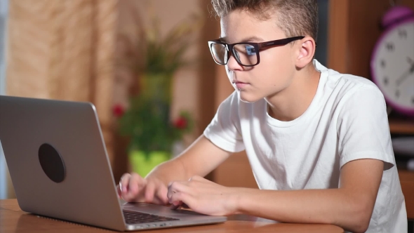 Teen Boy Working On Laptop