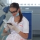 Female Dentist Uses Cellphone At The Dental Clinic - VideoHive Item for Sale