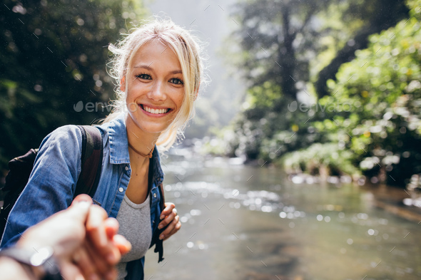 Woman enjoying a hike in nature with her boyfriend - Stock Photo - Images