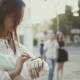 Woman Uses Smartwatch Standing In Old City  - VideoHive Item for Sale