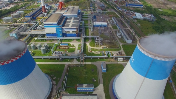 aerial view of power plant with large pipes